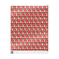 This festive Christmas gift wrap features a retro Midcenturyprint of a woman wearing a Christmas tree hat with a red background and black and white starbursts.