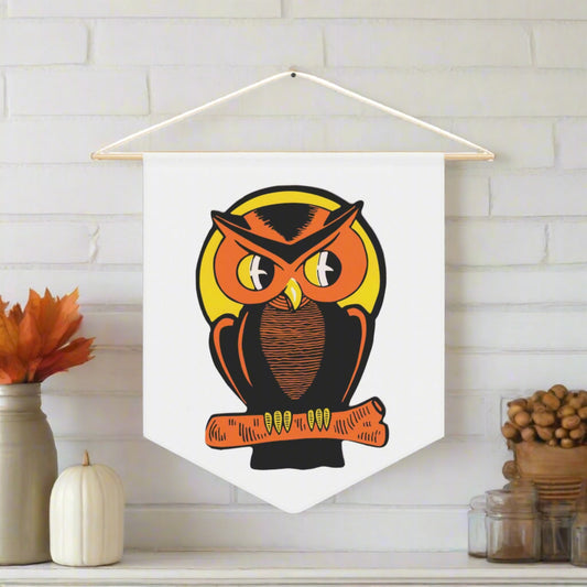 This pennant banner flag wall hanging features a vintage Halloween illustration of a beautiful Orange and black owl perched on a branch with the full yellow moon behind him. 