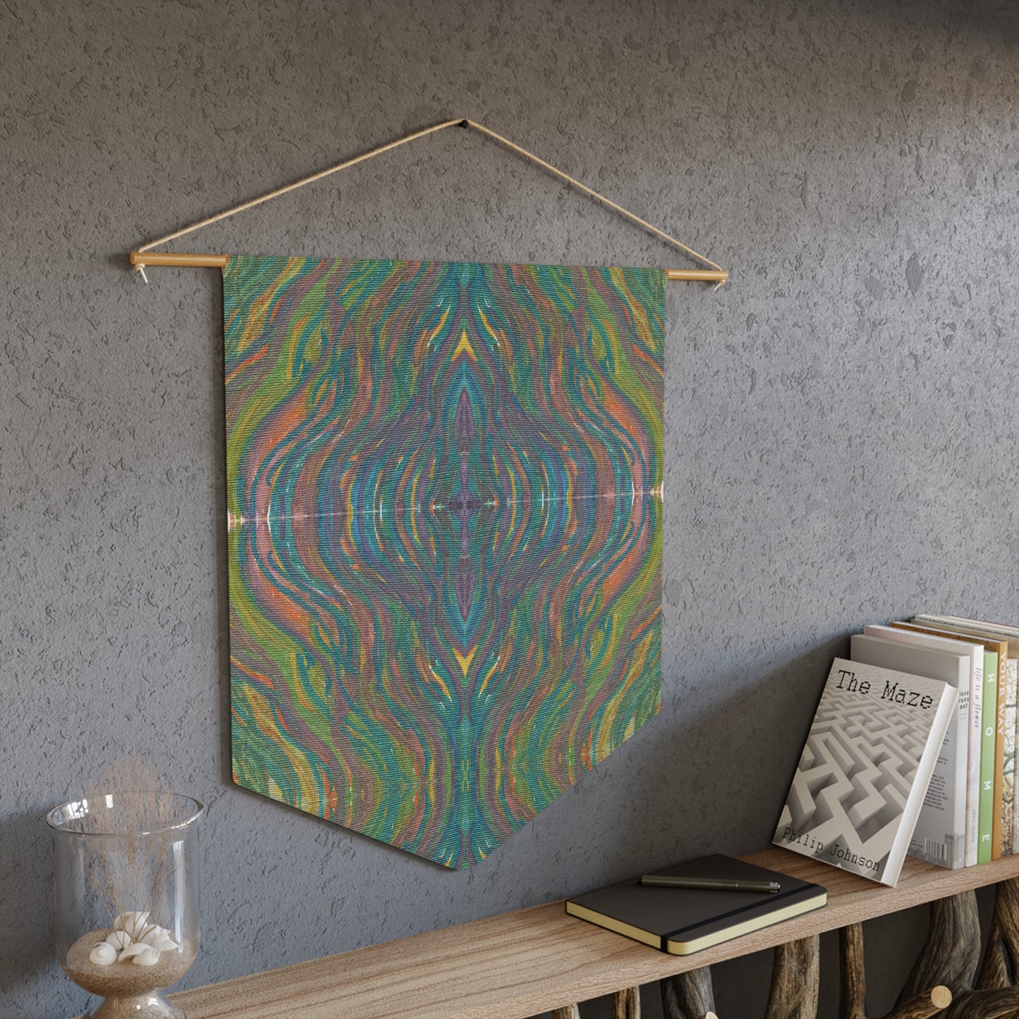 This fabric wall hanging by Caden Caraco features swirls of greens, yellows, blues, purples all blended.