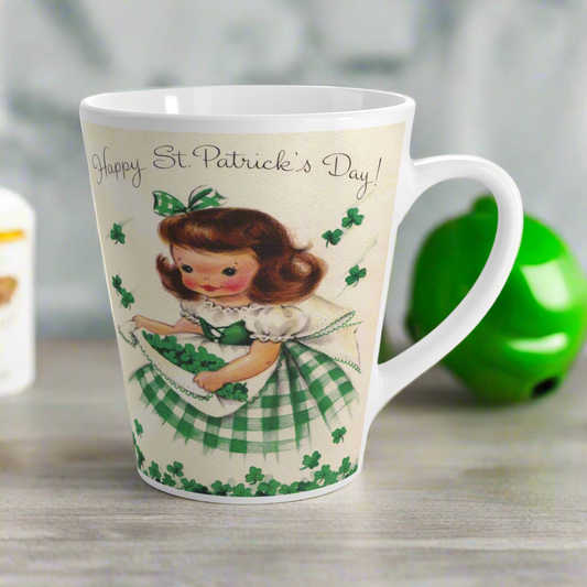 This ceramic latte mug features a vintage midcentury retro illustration of a girl gathering shamrocks.