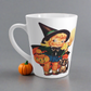 This ceramic glossy latte coffee cup features a retro vintage Halloween print of a young witch holding a broom and jack o lantern with a little brown cat sitting next to her.