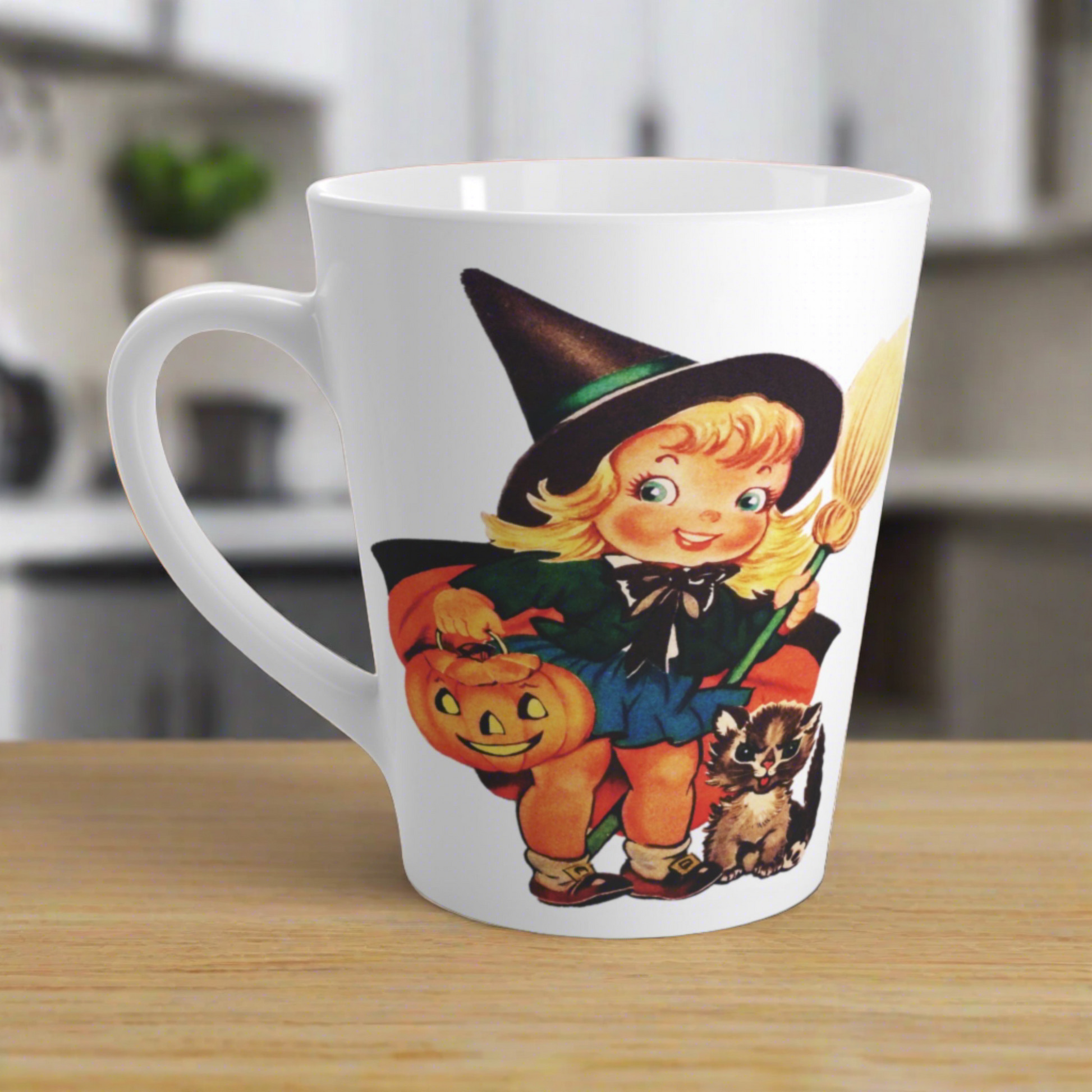 This ceramic glossy latte coffee cup features a retro vintage Halloween print of a young witch holding a broom and jack o lantern with a little brown cat sitting next to her.