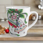 This ceramic glossy latte coffee cup features a vintage Christmas illustration of two holiday bells with ribbon, pine and berries. The design on the bells is reminiscent of European Scandinavian Christmas decorations.