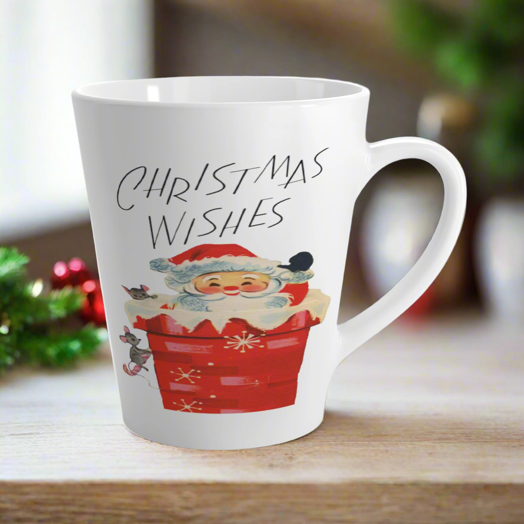 This glossy ceramic latte coffee mug says Christmas Wishes and features a retro Midcentury illustration of Santa peeking out of a snowy chimney with two mice.