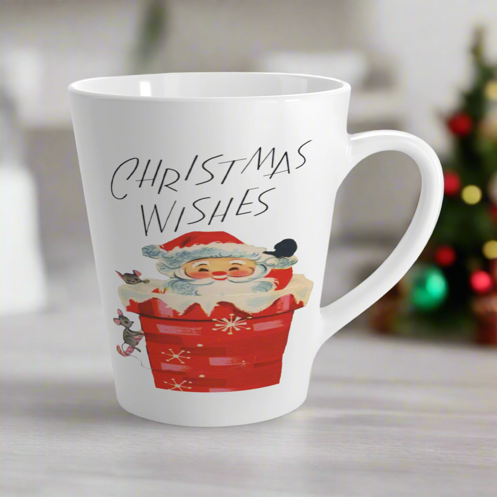 This glossy ceramic latte coffee mug says Christmas Wishes and features a retro Midcentury illustration of Santa peeking out of a snowy chimney with two mice.