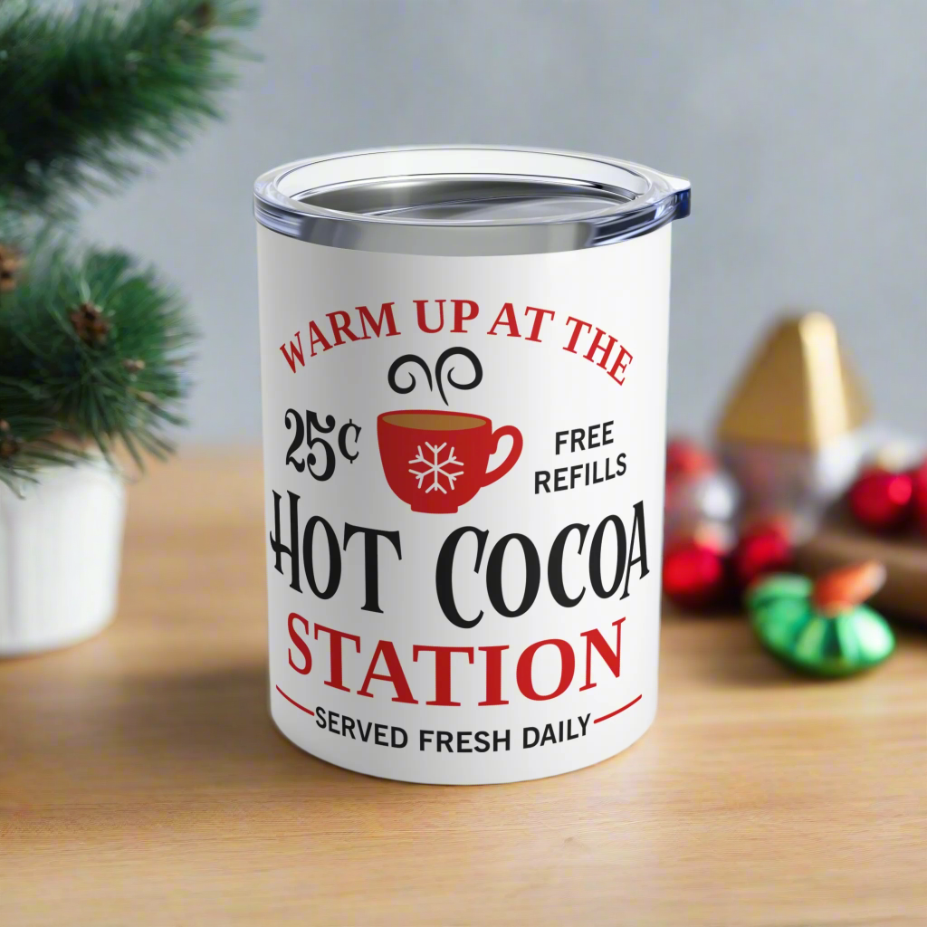 This white 10 ounce stainless steel tumbler mug says Warm Up At The Hot Cocoa Station Served Daily. 25 cent free refills. There is a little red coffee cup with a snowflake on it.