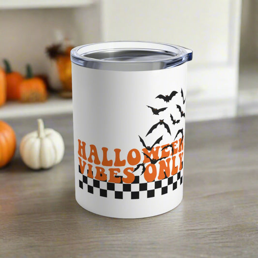 This 10 ounce stainless steel travel tumbler mug features orange retro lettering that says Halloween Vibes Only with black and white checkered print with flying bats. 