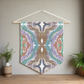 This canvas wall hanging by Caden Caraco features ethereal space feathers in colors of green, blue, copper and gold.