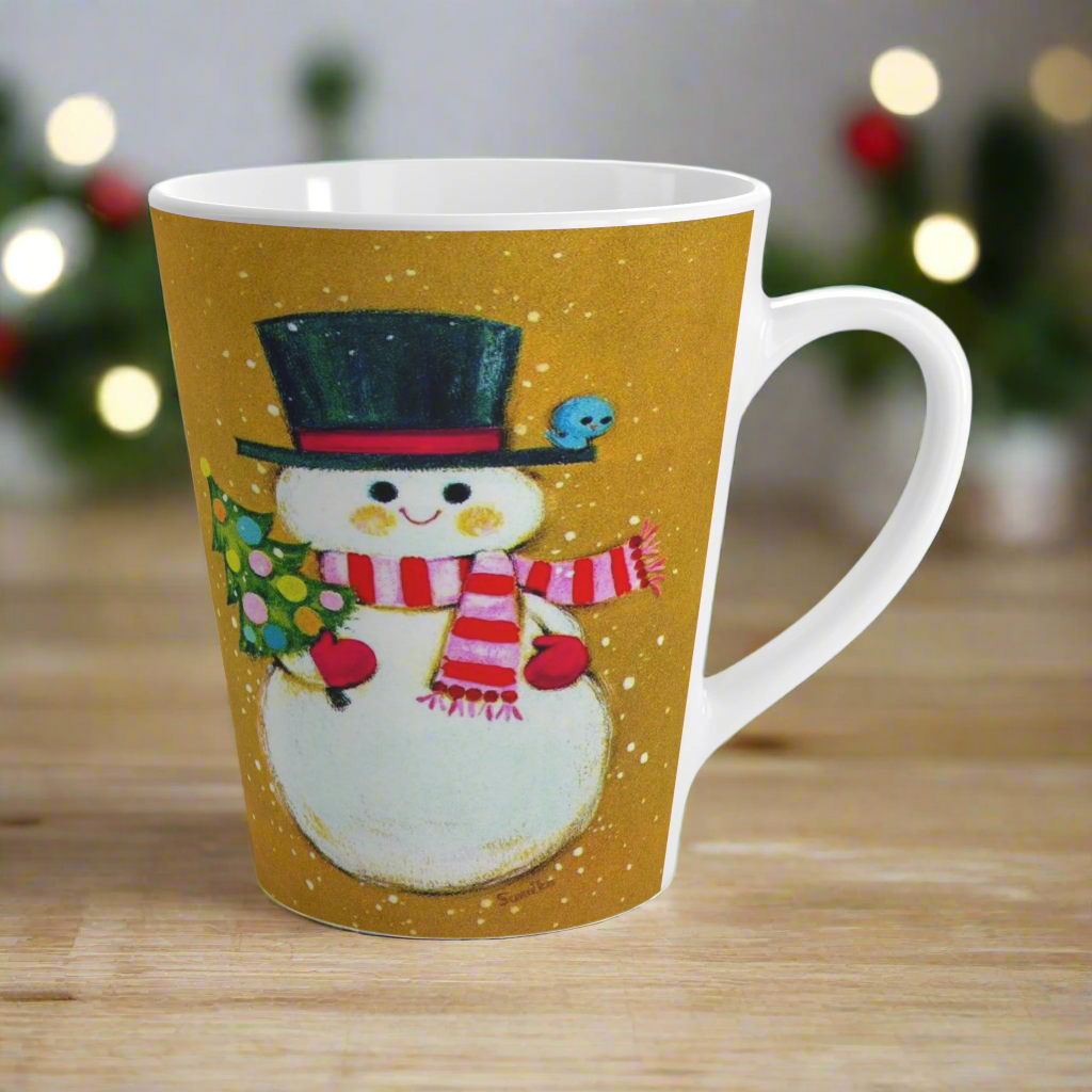 This ceramic latte coffee mug features an adorable retro mod Snowman. He is wearing a top hat and striped scarf, red gloves, and is holding a cute little christmas tree adorned with colorful round ornaments. There is a bluebird perched on his hat brim. It is an adorable mug perfect for gifting.