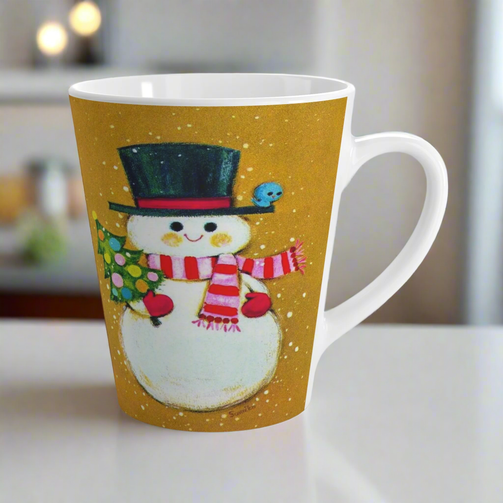 This ceramic latte coffee mug features an adorable retro mod Snowman. He is wearing a top hat and striped scarf, red gloves, and is holding a cute little christmas tree adorned with colorful round ornaments. There is a bluebird perched on his hat brim. It is an adorable mug perfect for gifting.