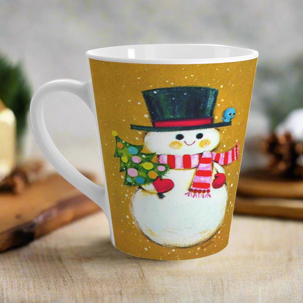 This ceramic latte coffee mug features an adorable retro mod Snowman. He is wearing a top hat and striped scarf, red gloves, and is holding a cute little christmas tree adorned with colorful round ornaments. There is a bluebird perched on his hat brim. It is an adorable mug perfect for gifting.