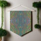 This fabric wall hanging by Caden Caraco features swirls of greens, yellows, blues, purples all blended.This fabric wall hanging by Caden Caraco features swirls of greens, yellows, blues, purples all blended.