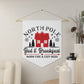 This white Christmas wall hanging pennant banner flag says North Pole Bed and Breakfast Warm Fire and Cozy Beds. It features a red house with trees and stars.