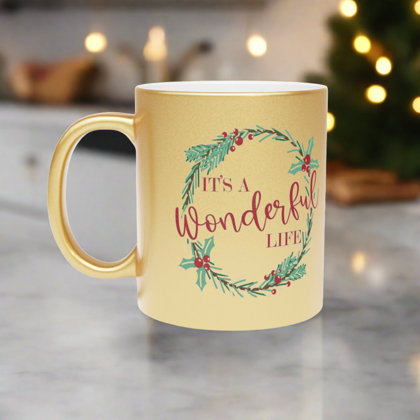 This gold metallic ceramic mug features a holly wreath with red lettering that says It's a Wonderful Life.