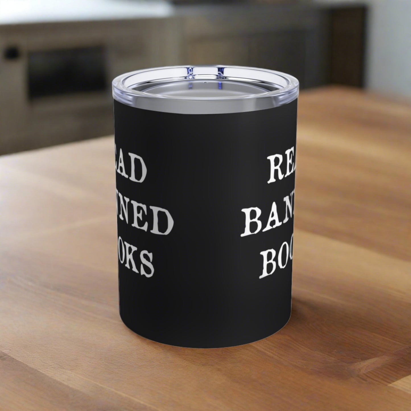 This 10 ounce black tumbler travel mug features white lettering that says Read Banned Books.This 10 ounce black stainless steel insulated travel tumbler mug features white letters that say Read Banned Books. The tumbler comes with a plastic sipping lid.