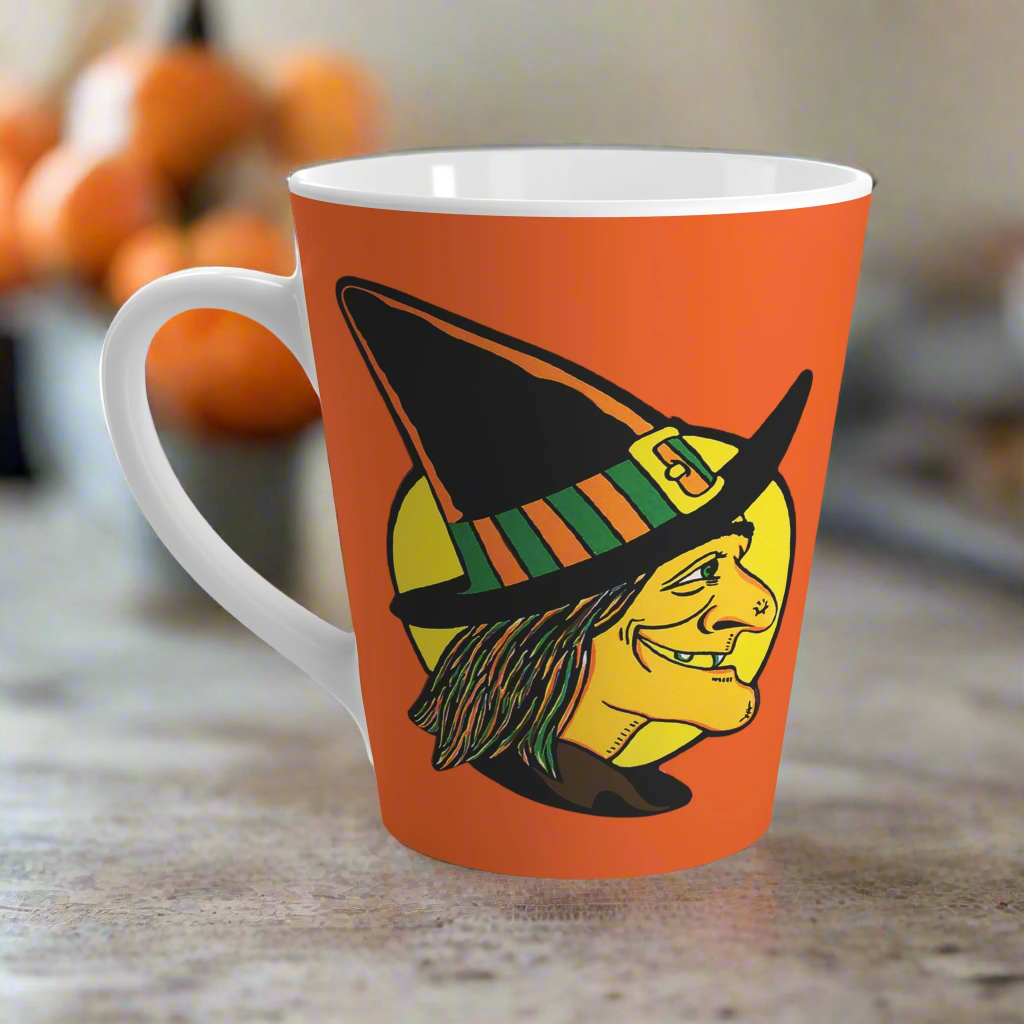 This 12 ounce ceramic latte coffee mug features a midcentury retro Halloween print of a profile of a witch with a full yellow moon behind her.