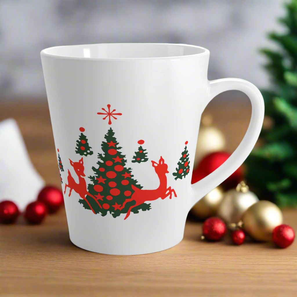 This ceramic glossy latte coffee mug features a midcentury retro illustration of red reindeer and green christmas trees with red ornaments.