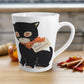 This glossy ceramic latte mug features a retro vintage Halloween illustration of a black cat with orange eyes. She is wearing an orange bow with a tag that says Happy Halloween.