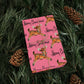 This pink gift wrap features a midcentury illustration of a leaping reindeer adorned with an ornament wreath around her neck. There is black lettering that says Merry Christmas.