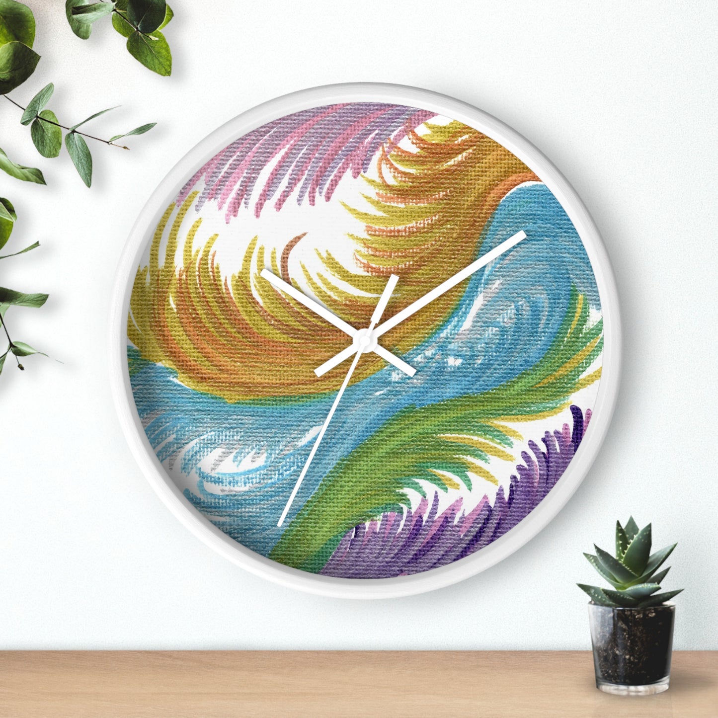 This white wall clock features the original artwork of Caden Caraco titled Space Feathers. Original medium is pen on canvas.  It features swirls in pink, purple, gold, blue and green.