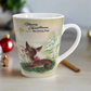 This ceramic latte coffee mug features a midcentury vintage Christmas illustration featuring Rudolph the Red Nosed Reindeer sitting down looking up at a gold star in the sky surrounded by snowy trees. It says: Merry Christmas Says Rudolph.