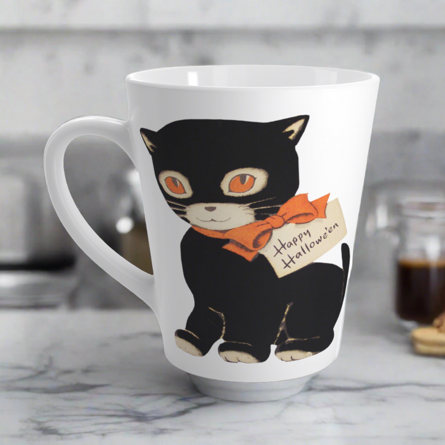 This glossy ceramic latte mug features a retro vintage Halloween illustration of a black cat with orange eyes. She is wearing an orange bow with a tag that says Happy Halloween.