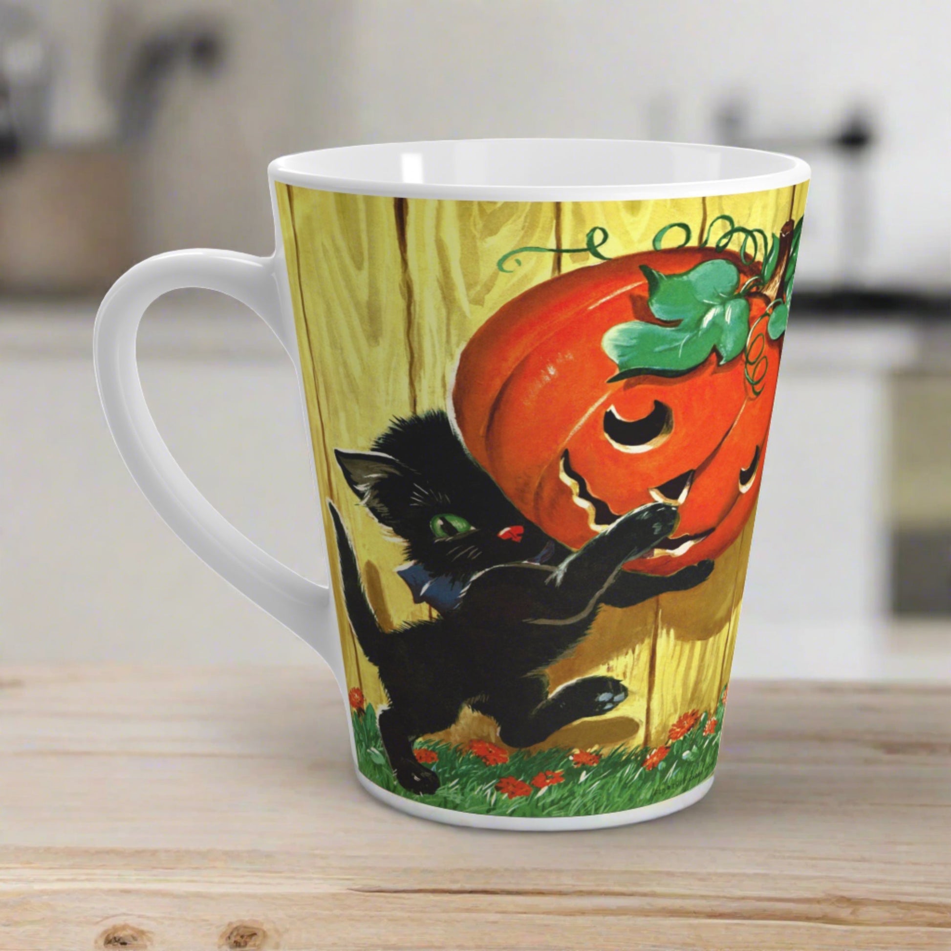 This glossy ceramic latte mug features a vintage Halloween illustration featuring a black kitty carrying a Jack 'o Lantern.