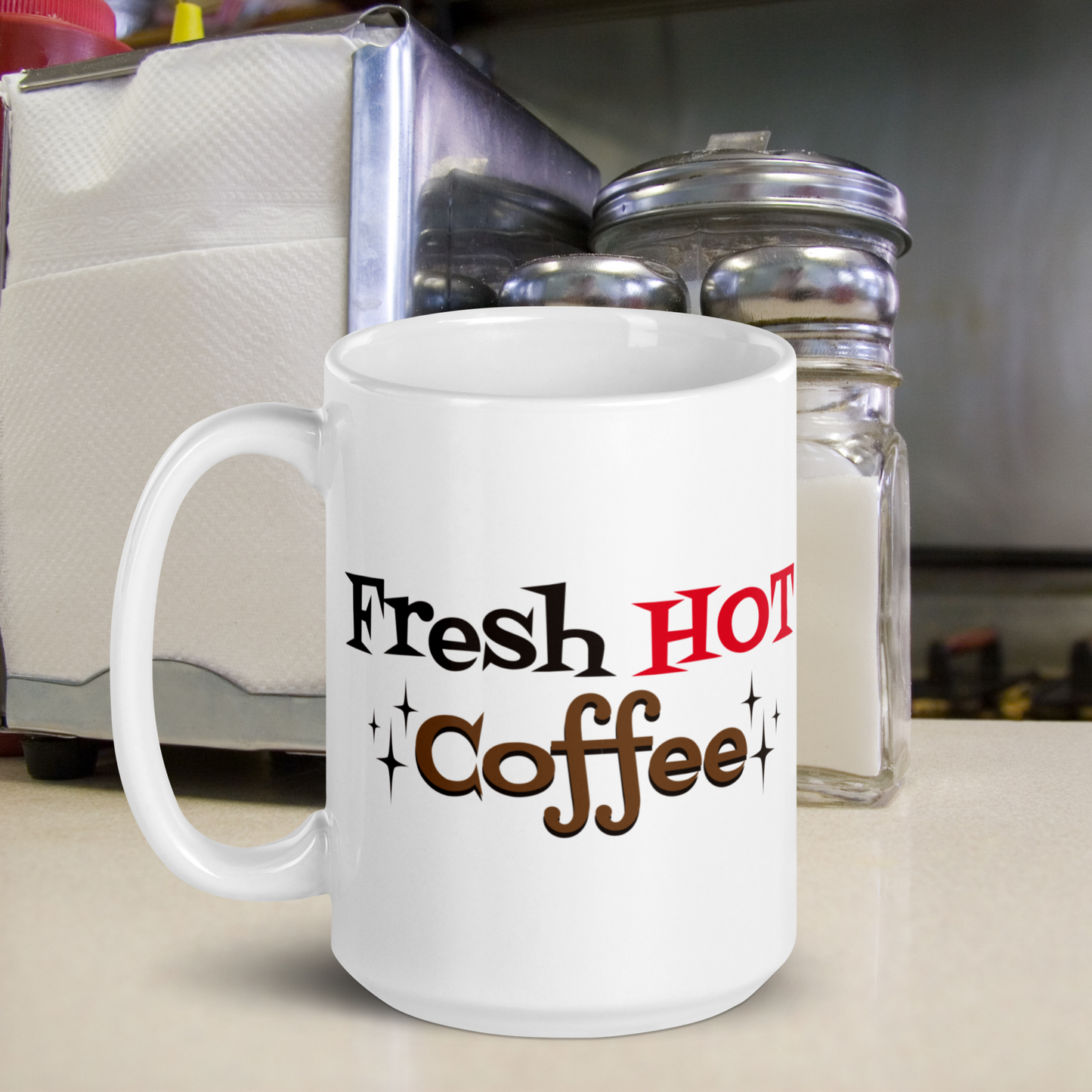 The ceramic white glossy mug features atomic era lettering that says Fresh HOT Coffee with starbursts around the word coffee. Fresh lettering is black, HOT is in red, and coffee is brown with a black shadowing.