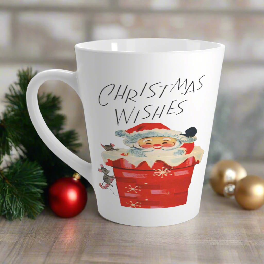 This glossy ceramic latte coffee mug says Christmas Wishes and features a retro Midcentury illustration of Santa peeking out of a snowy chimney with two mice.