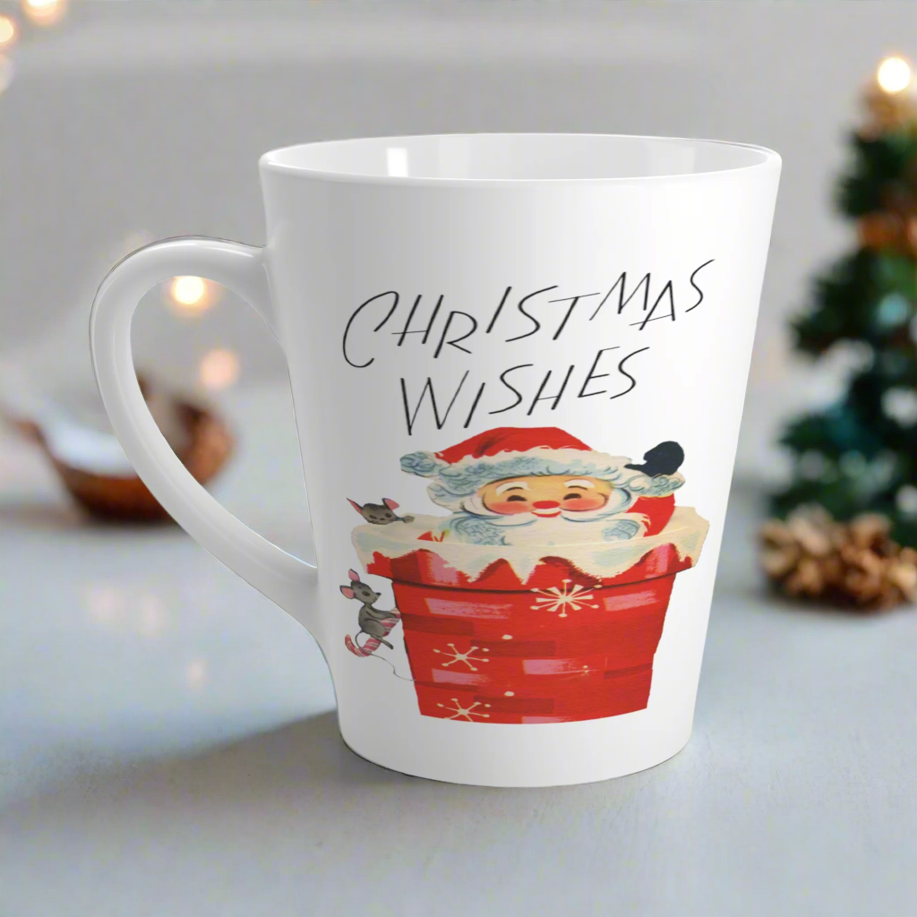 This glossy ceramic latte coffee mug says Christmas Wishes and features a retro Midcentury illustration of Santa peeking out of a snowy chimney with two mice.