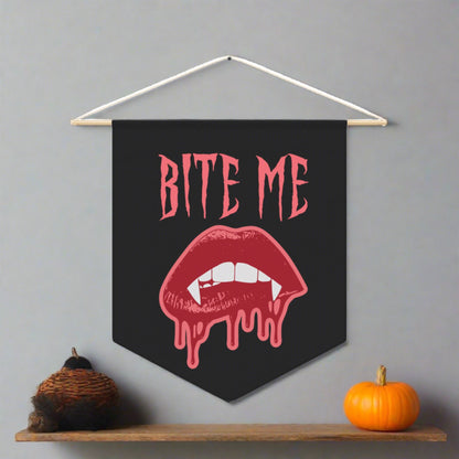 This pennant banner wall hanging features pink gothic lettering that says Bite Me with vampire lips and fangs dripping with blood beneath. 