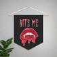 This pennant banner wall hanging features pink gothic lettering that says Bite Me with vampire lips and fangs dripping with blood beneath. 