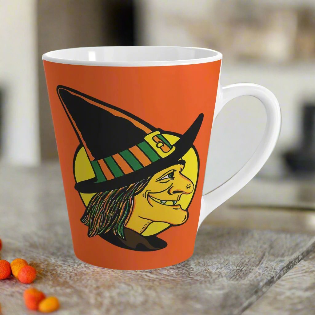 This 12 ounce ceramic latte coffee mug features a midcentury retro Halloween print of a profile of a witch with a full yellow moon behind her.