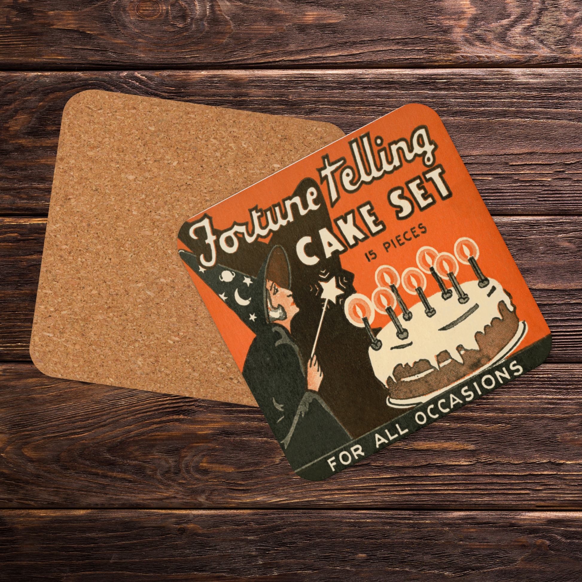 This square cork-back coaster features a retro Halloween illustration that says Fortune Telling Cake Set 15 pieces. There is a witchholding a star magic wand that she is waving over her cake with candles.