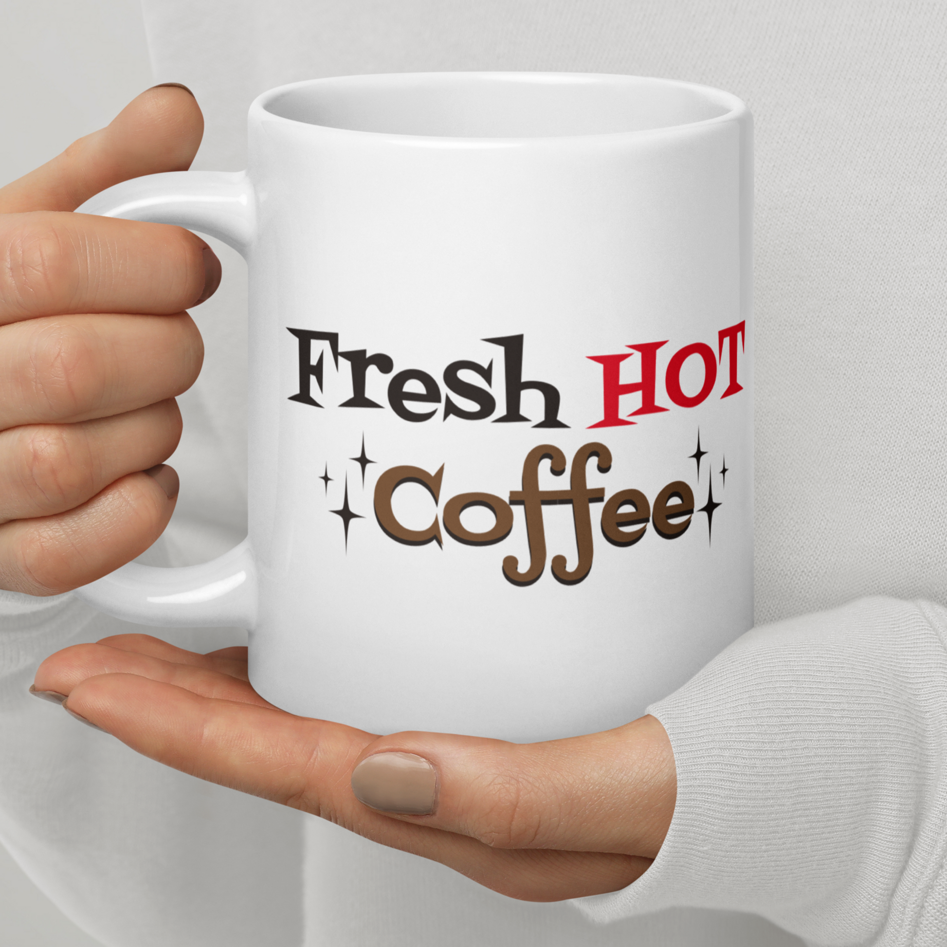 The ceramic white glossy mug features atomic era lettering that says Fresh HOT Coffee with starbursts around the word coffee. Fresh lettering is black, HOT is in red, and coffee is brown with a black shadowing.