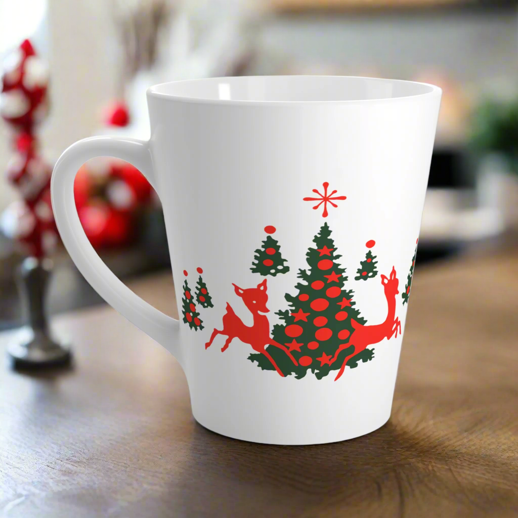 This ceramic glossy latte coffee mug features a midcentury retro illustration of red reindeer and green christmas trees with red ornaments.