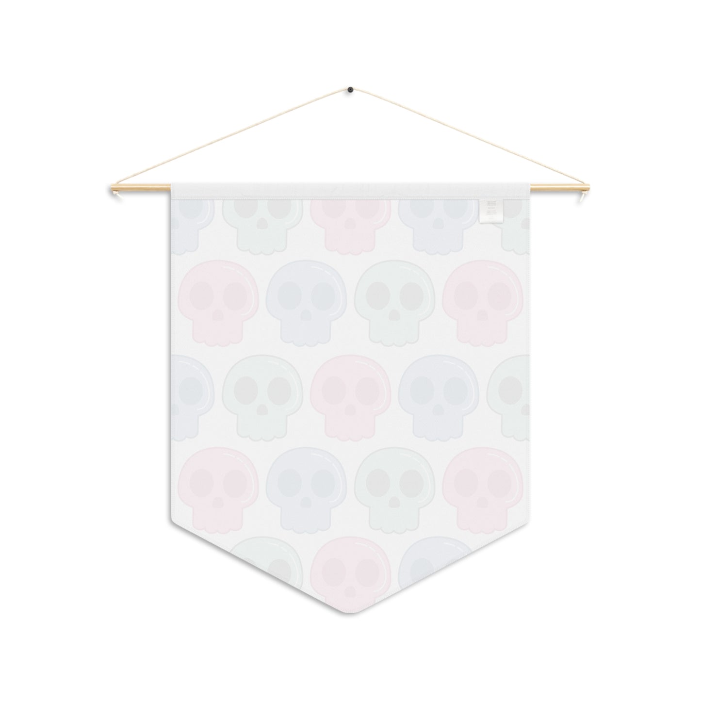 This pennant banner wall hanging features cute pastel goth skulls patterned in pink, green and blue with a white background on fabric canvas. It hands on a wooden dowel. The back is white.