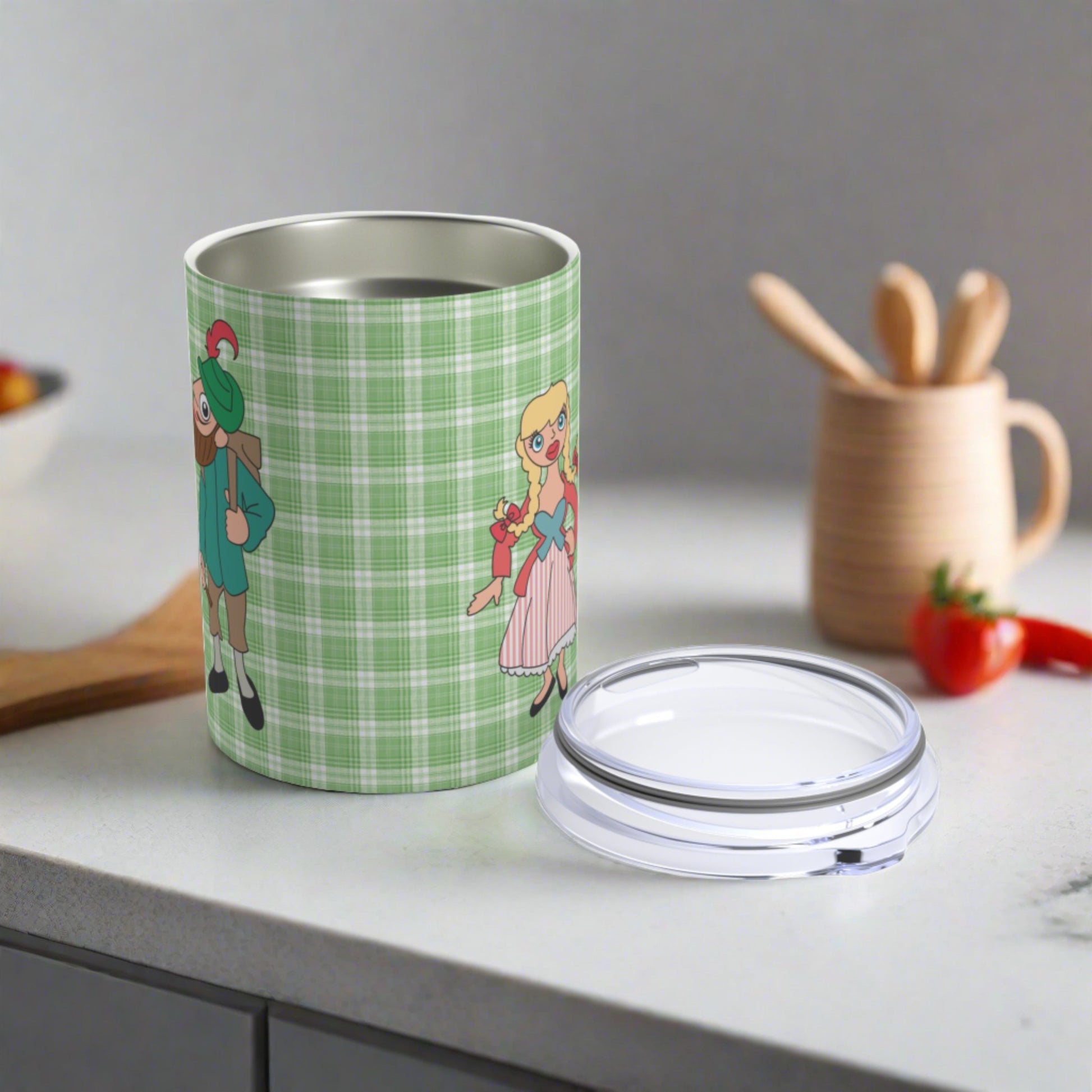 This 10 ounce travel tumbler mug features characters from the Sound of Music Lonely Goatherd song: The Goatherd, the girl in the pale pink coat, and the baby goat. The background is green plaid. The mug comes with a plastic sipping lid.