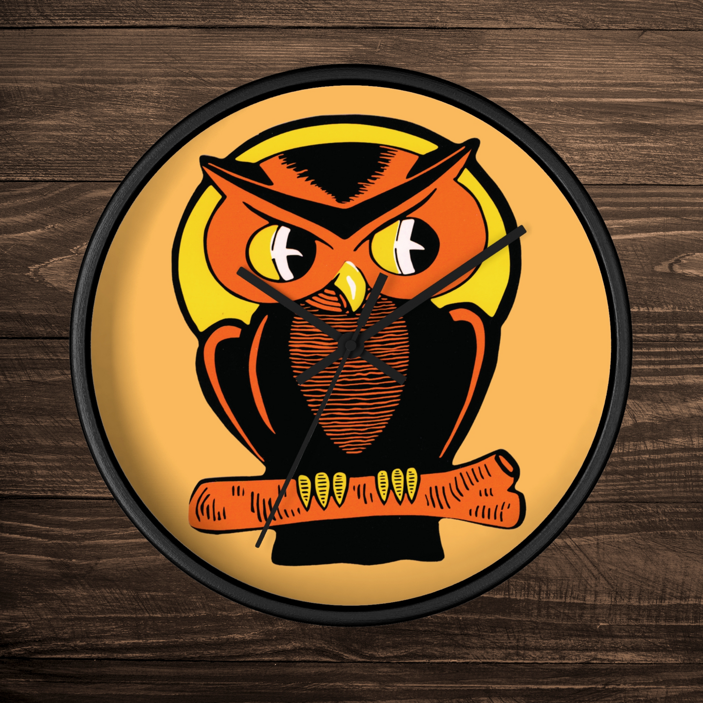 This black wooden wall clock features a retro illustration of an orange and black owl with a yellow full moon. The frame and hands of the clock are black.