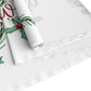 This white Christmas table runner features red lettering that says It's A Wonderful Life inside a holly berry wreath.