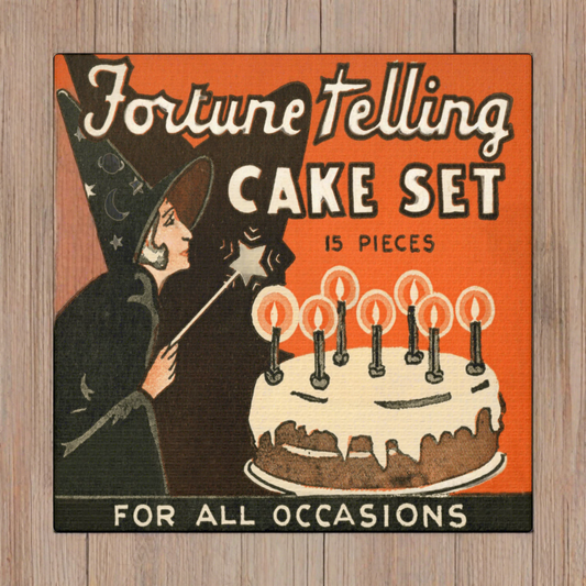 This rare vintage Halloween artwork features a celestial witch with a star wand and a cake. The lettering Fortune Telling Cake Set For All Occassions is featured with an orange background.