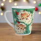 This ceramic glossy latte Christmas mug features a vintage Midcentury illustration of six laughing santas with holly berries.