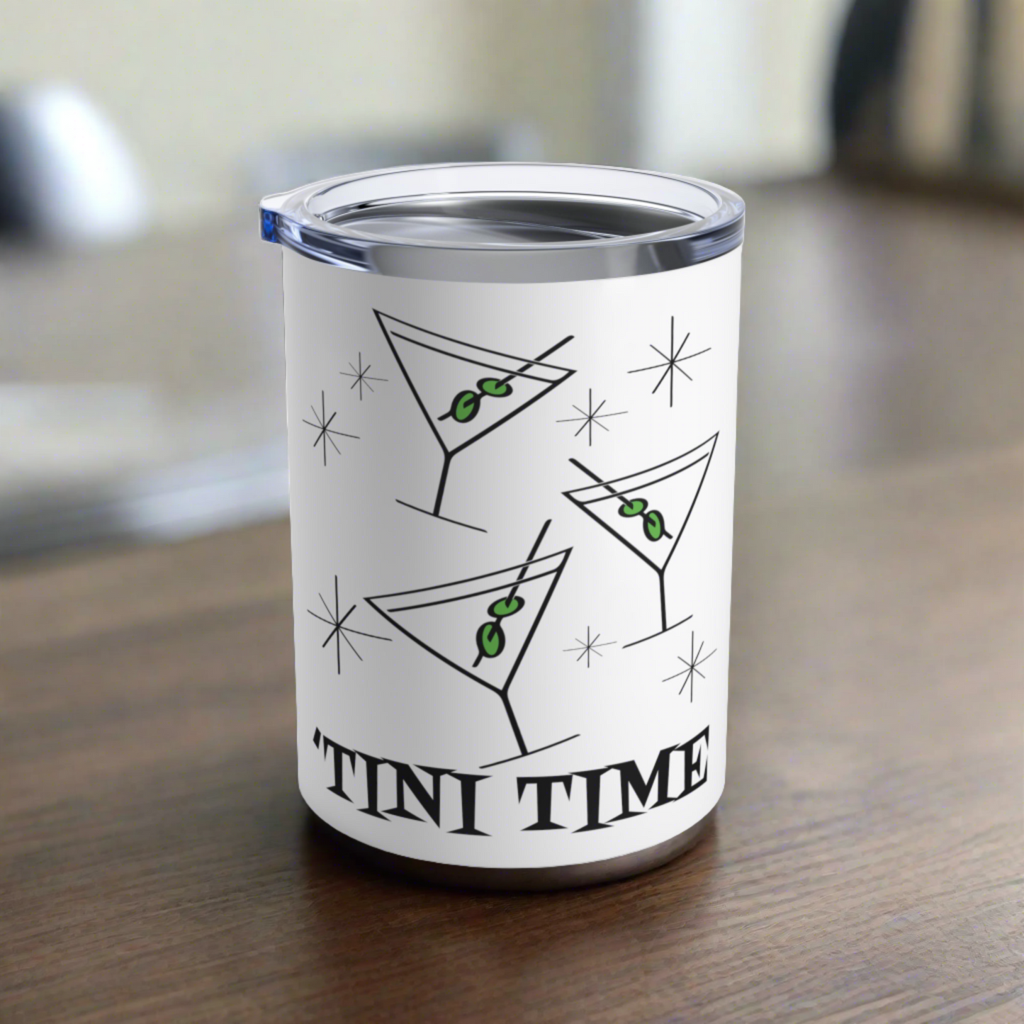 This 10 ounce white stainless steel tumbler features three martini glasses with green olives on toothpicks surrounded by stars and at the bottom the words say Tini Time in Atomic Retro Style lettering.