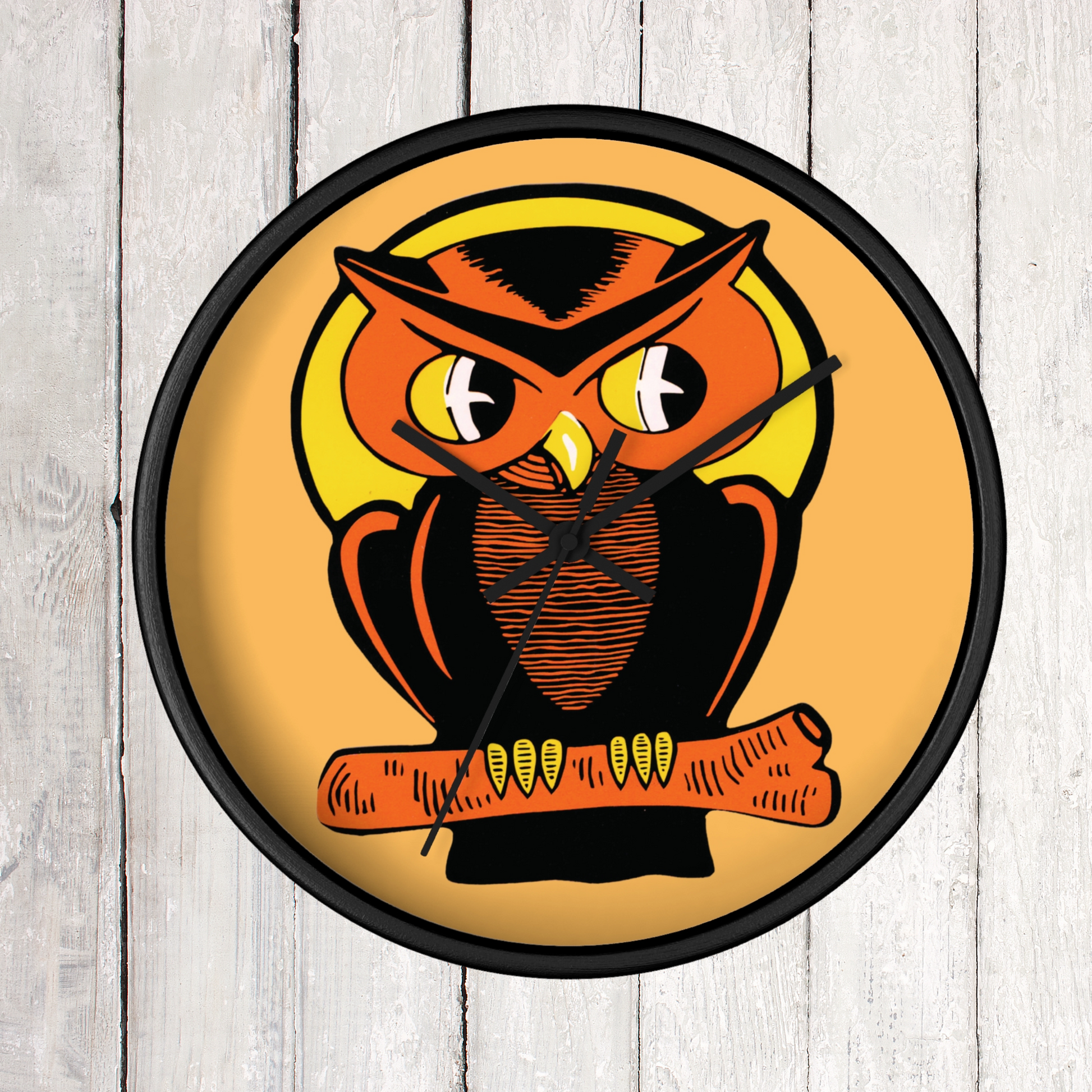 This black wooden wall clock features a retro illustration of an orange and black owl with a yellow full moon. The frame and hands of the clock are black.