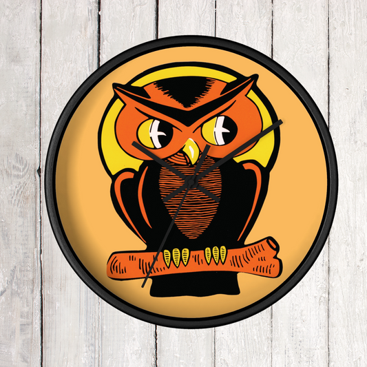 This black wooden wall clock features a retro illustration of an orange and black owl with a yellow full moon. The frame and hands of the clock are black.