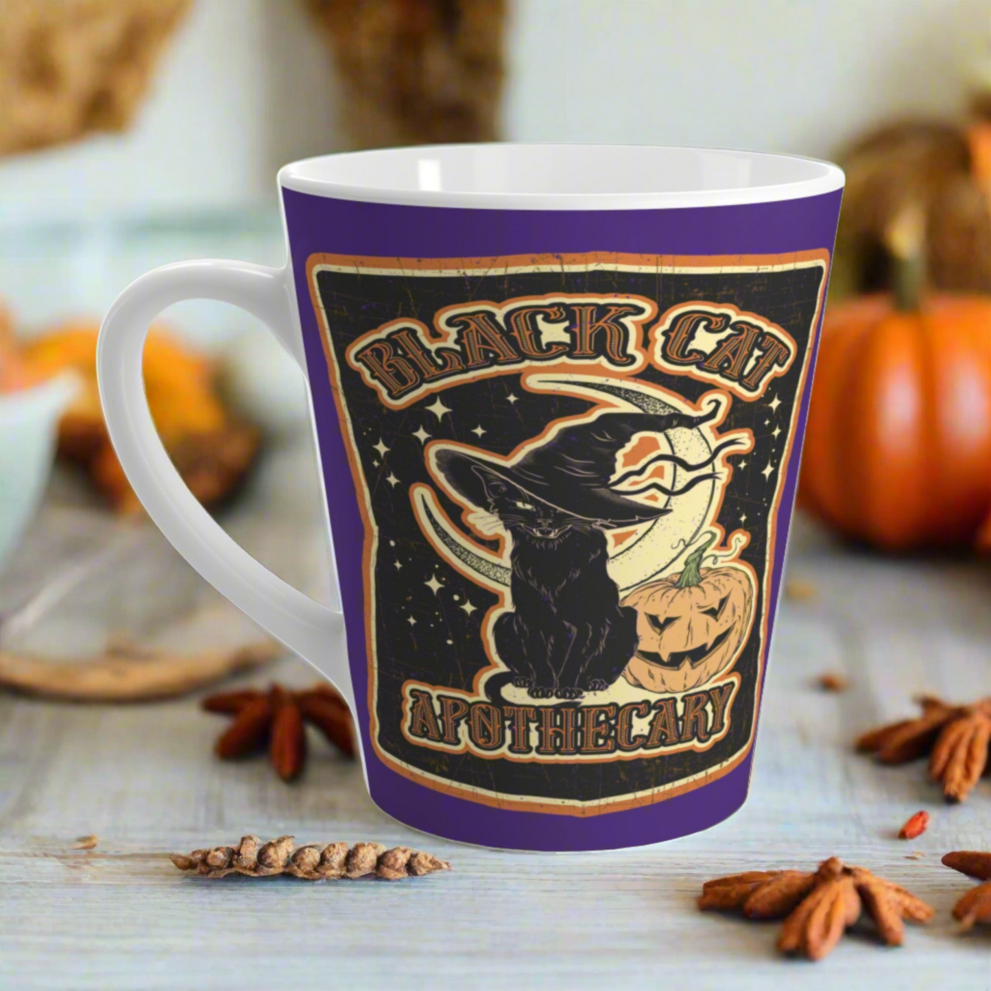 This 12 ounce ceramic glossy latte mug features Halloween distressed style print of a black cat wearing a witch's hat and says Black Cat Apothecary. There is a yellow moon and jack o'lantern.