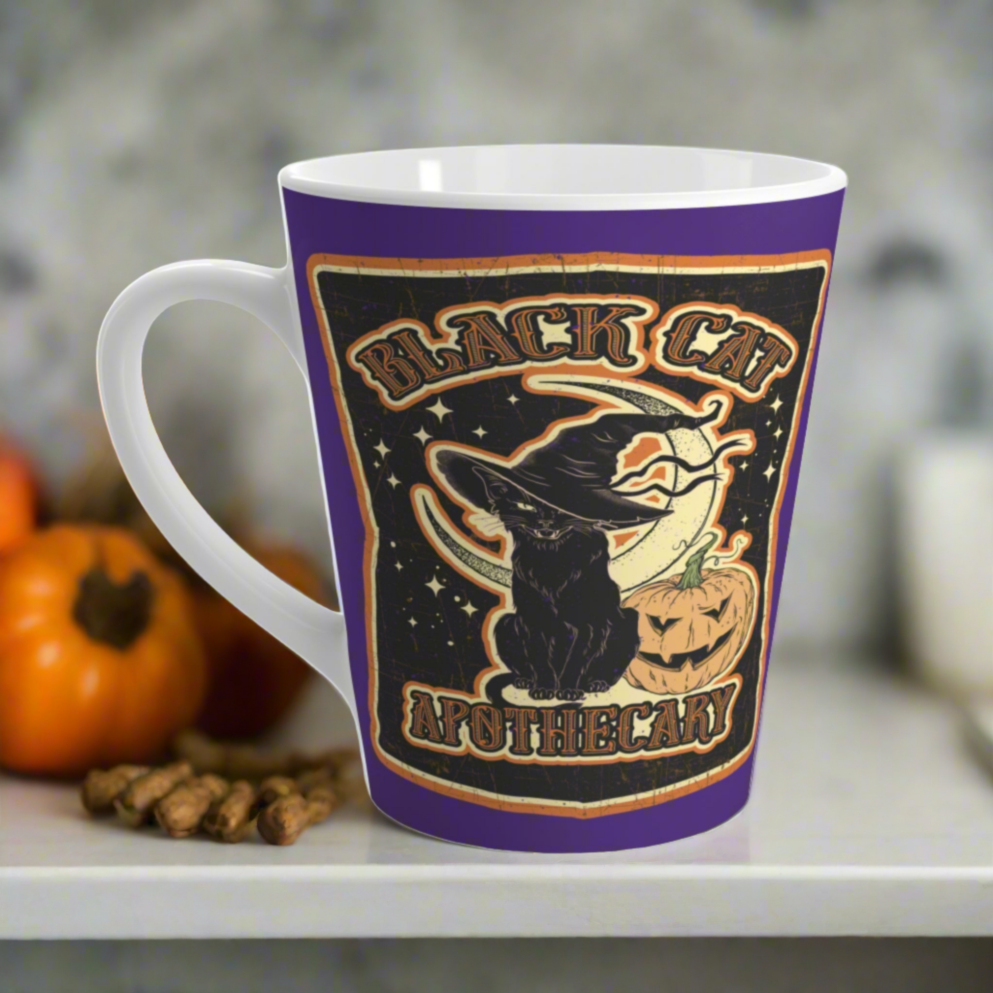 This 12 ounce ceramic glossy latte mug features Halloween distressed style print of a black cat wearing a witch's hat and says Black Cat Apothecary. There is a yellow moon and jack o'lantern.