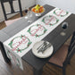 This white Christmas table runner features red lettering that says It's A Wonderful Life inside a holly berry wreath.