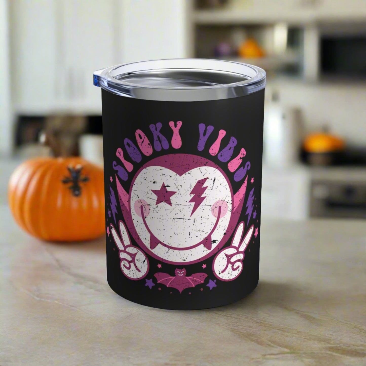 This 10 ounce stainless steel black travel tumbler mug features a distressed retro style illustration of Dracula and a bat that says Spooky Vibes.