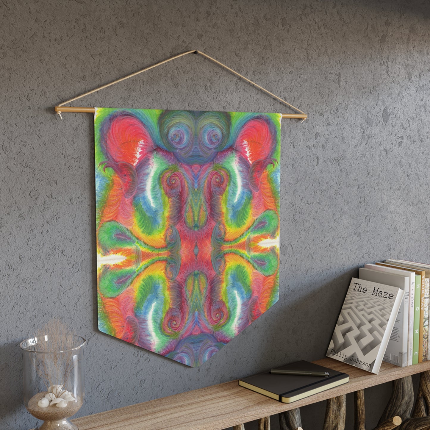 This fabric wall hanging features the hand drawn artwork of modern artist Caden Caraco. There are swirls of green, red, orange, yellows and purples. Original artwork is oil pastel on paper.